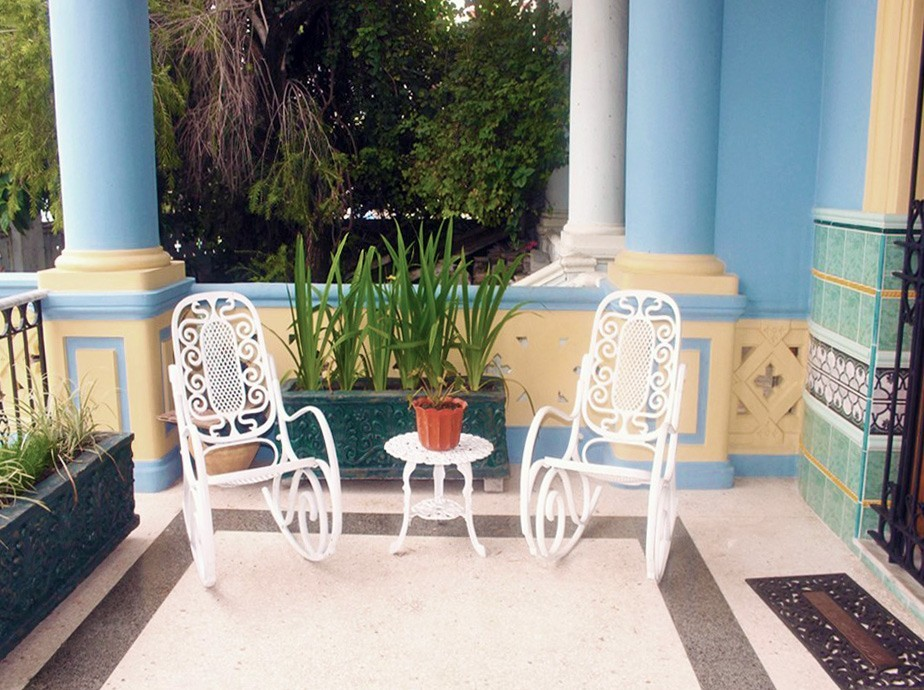 Classic Cuban rocking chairs on a porch in Havana
